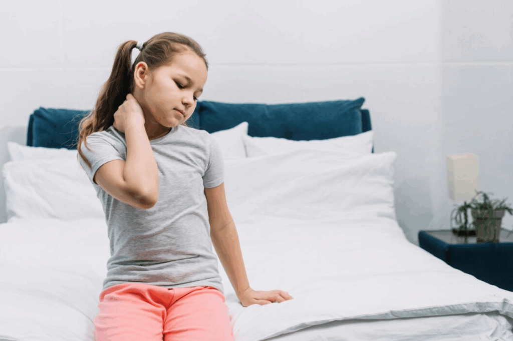 A child with back pain from backpack weight.