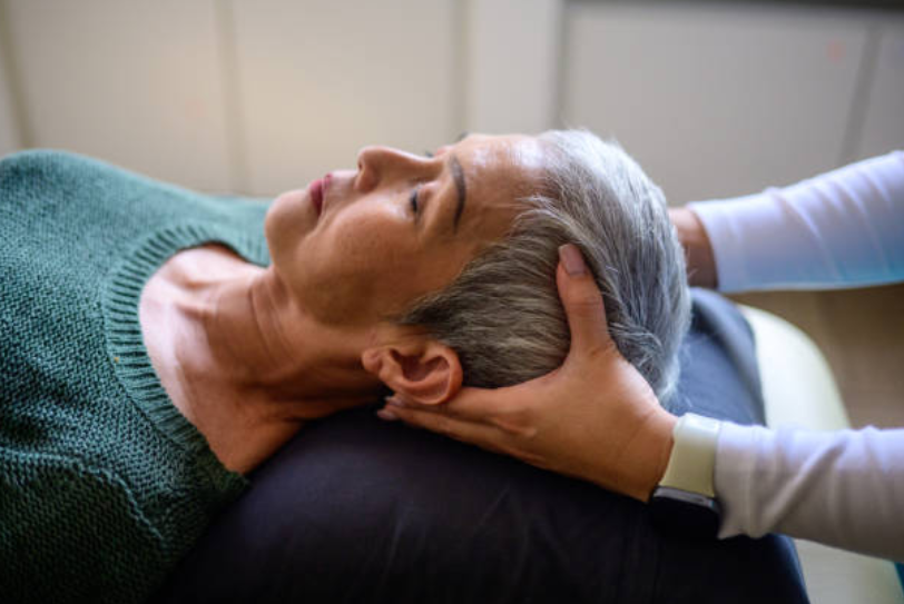 Woman receiving a chiropractic adjustment for head and neck relief.