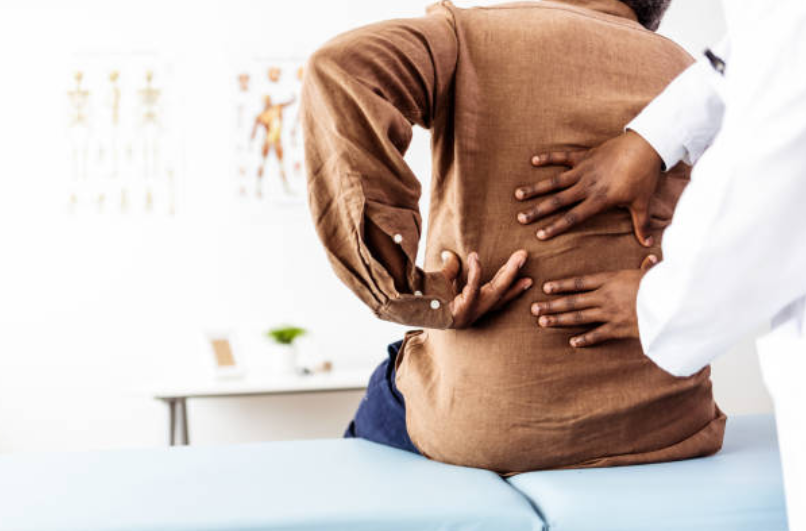 Chiropractor performing a lower back adjustment on a patient for pain relief.